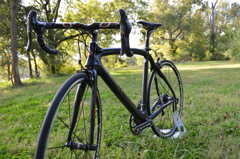 an old bike sits in the grass