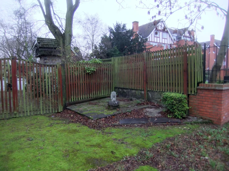 the fence is open on one side, while the ground is covered in dirt