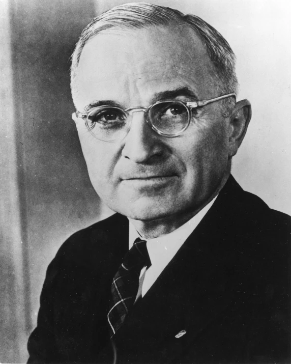 a black and white pograph of a man in glasses