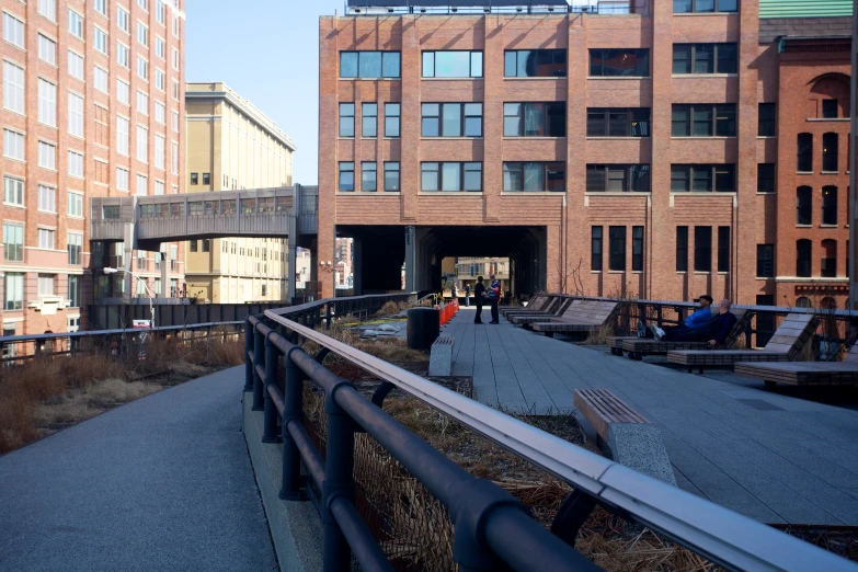 a pedestrian walkway in front of a brick building with windows and a sign that says, don't walk on the bridge