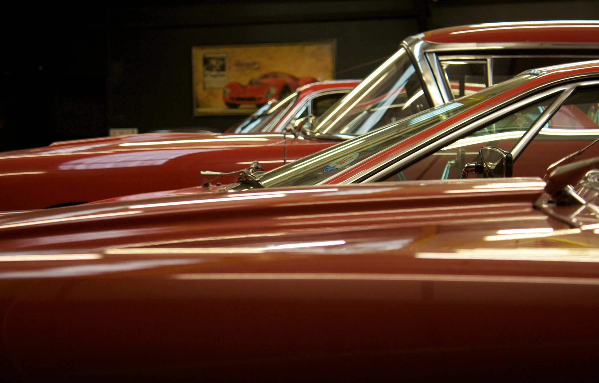 a row of old cars sitting in a garage