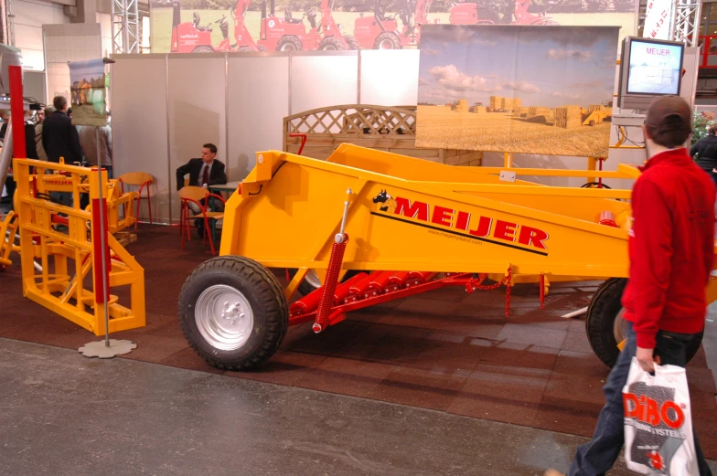 people in a room with yellow machinery