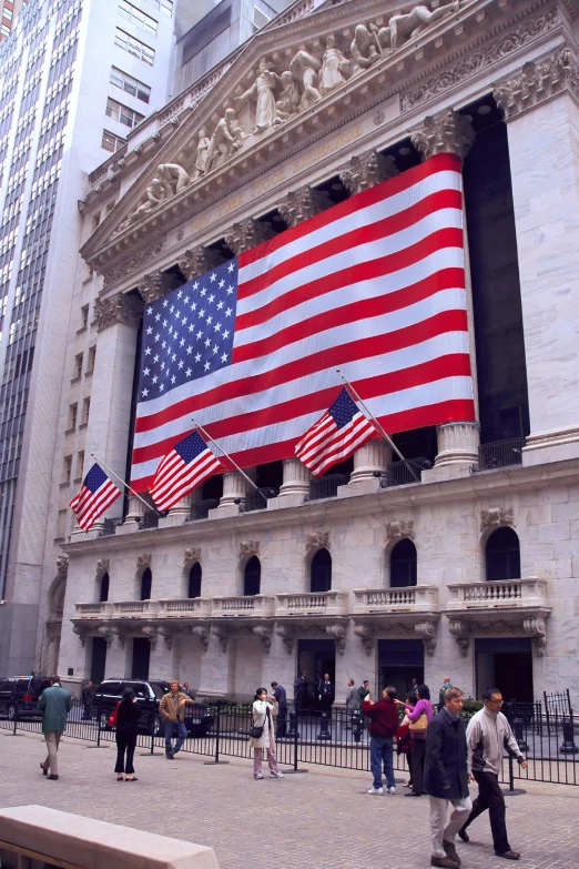 a large american flag is on display at the nyse