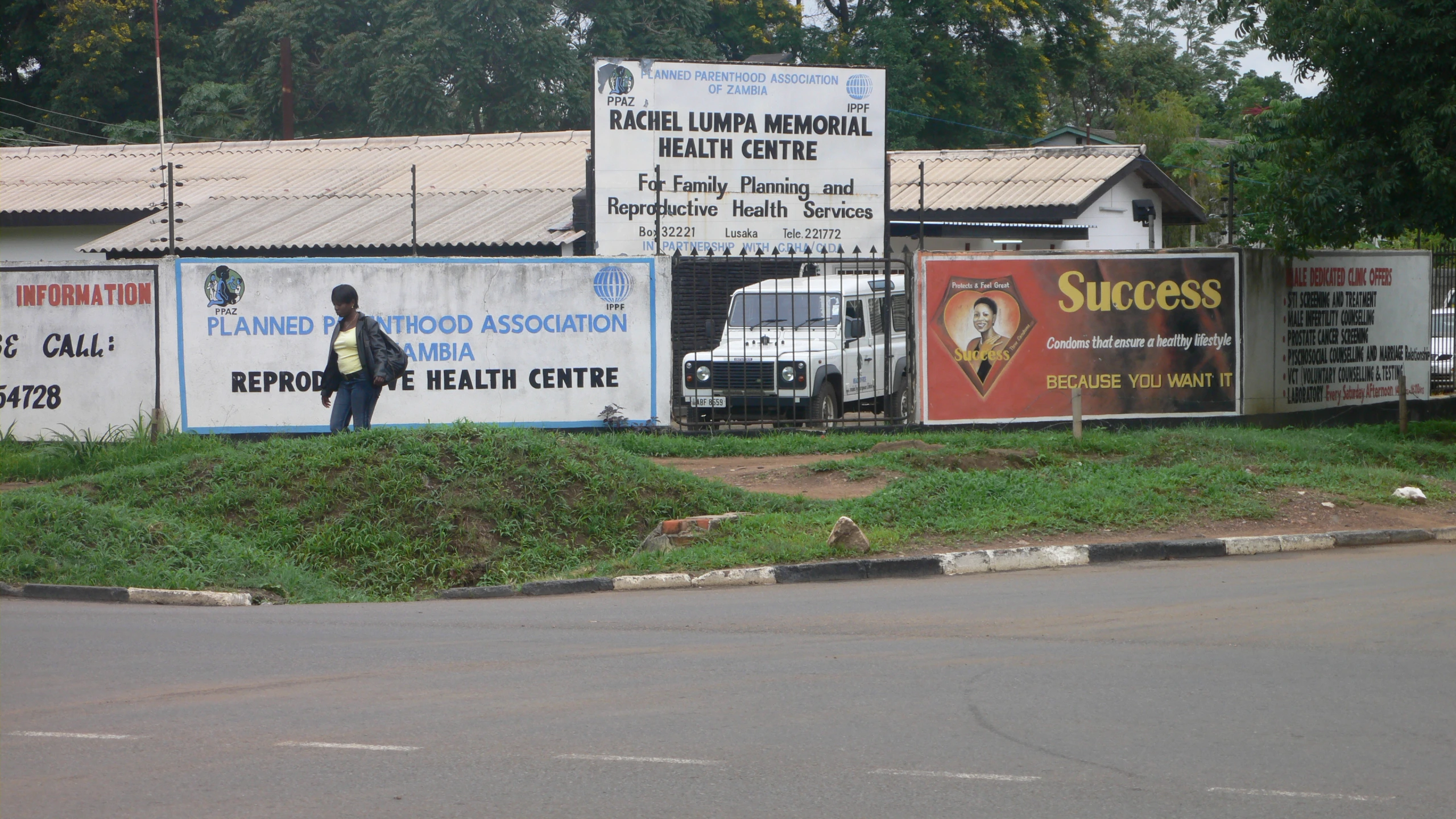 large billboards on sides of the street with signs behind them