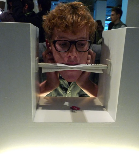 man in a pair of glasses looking in an empty refrigerator