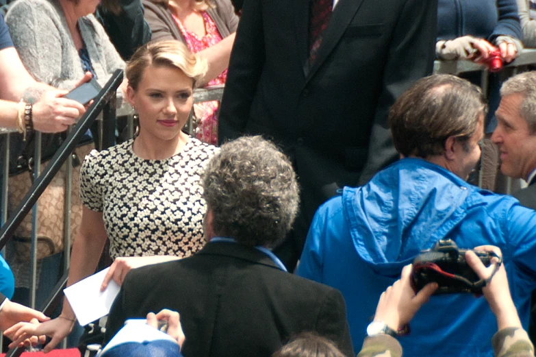 a woman talking to reporters at a public event