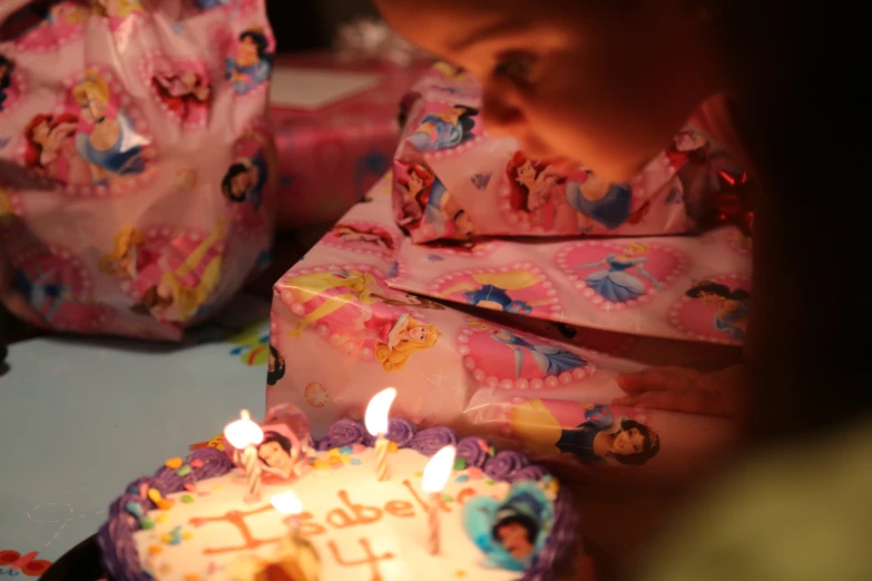 a birthday cake with lit candles on it