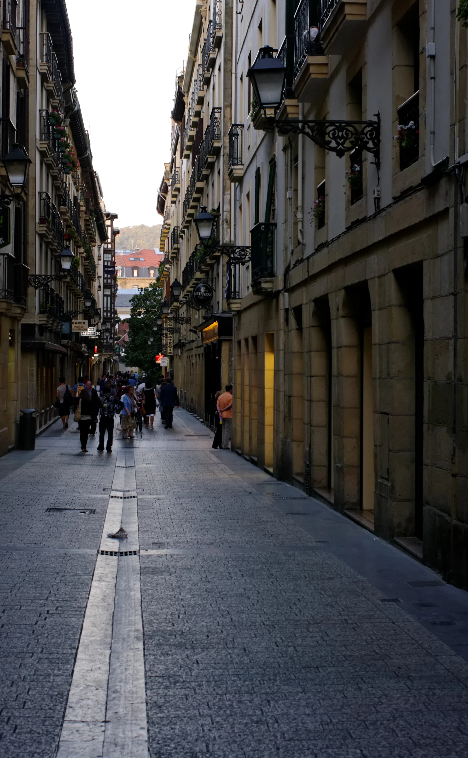 a street lined with buildings next to an empty street