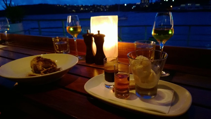 a dinner with a candle on the side and glasses