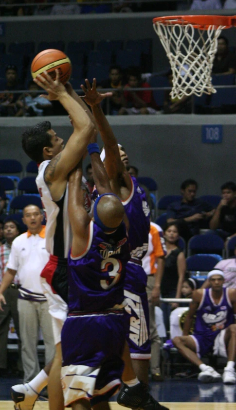 a group of men playing a game of basketball