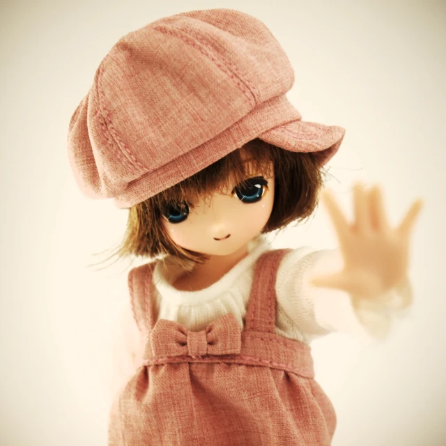 a little doll with a large hat on it's head