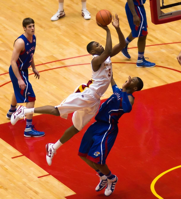 a basketball player in mid air shooting the ball