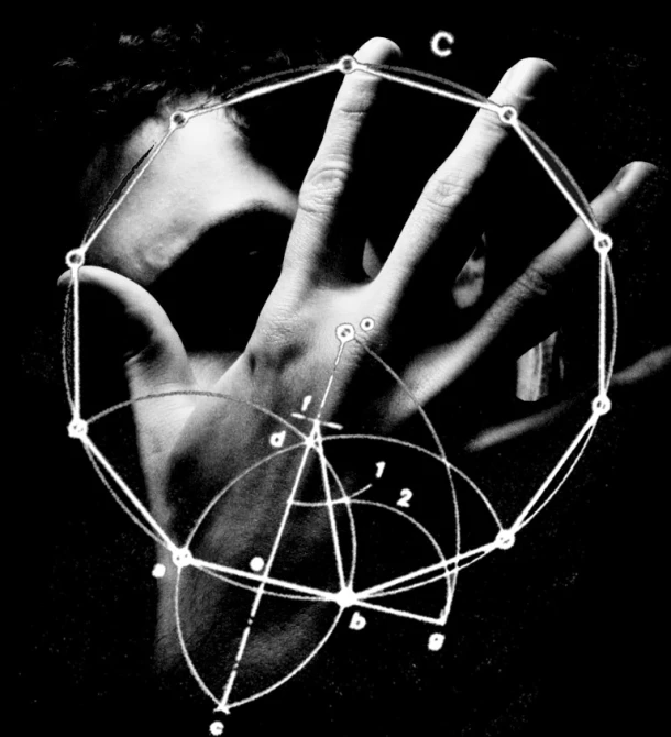 a hand touching a circular object in a black and white image