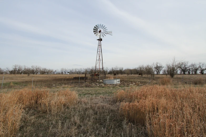 an old tower in a pasture that has a boat on it