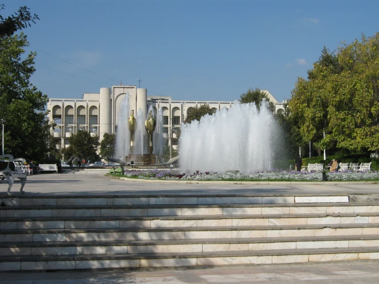 a large water fountain sitting on the side of a building