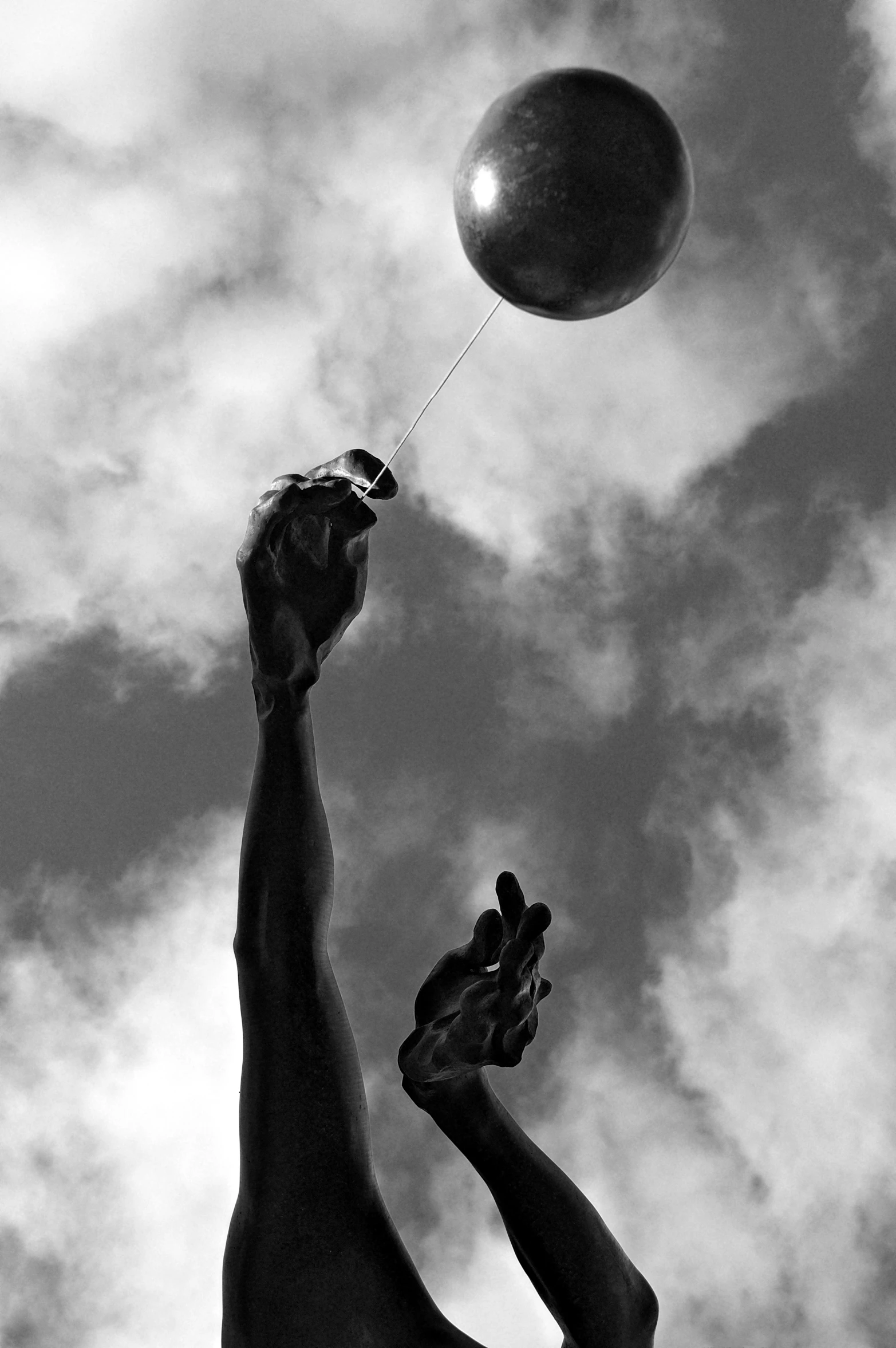 black and white pograph of a hand holding a flying ball