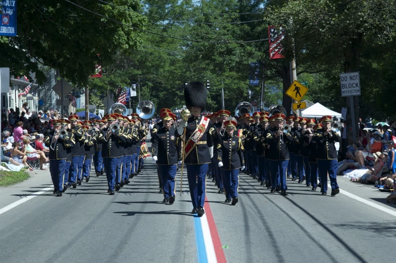 military unit on street carrying flag in parade