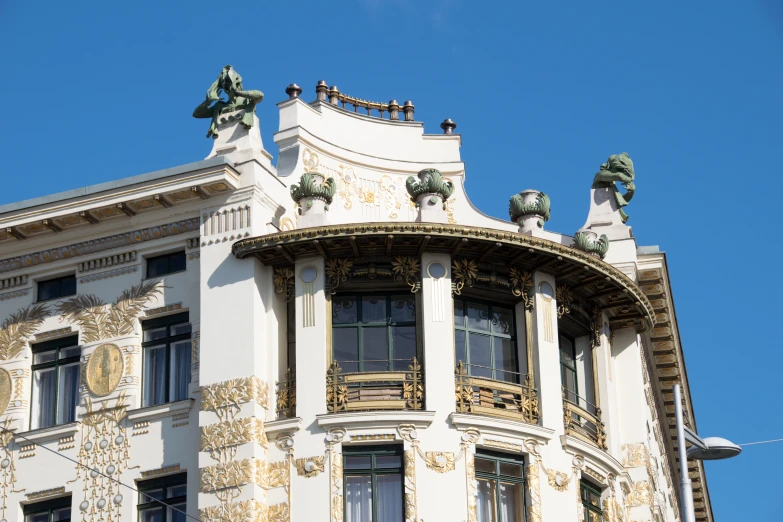 the architecture and roof on the building has statues on it