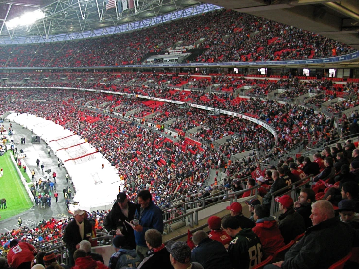 an empty stadium, filled with spectators at the end