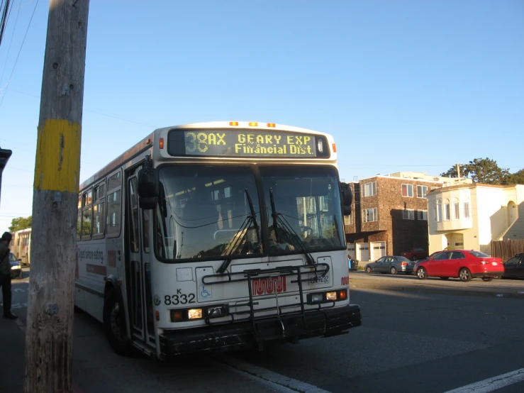 a bus parked on a street next to an empty pole