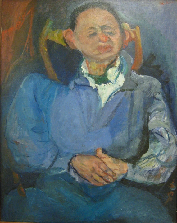 an older man sits in a chair with his hand on his hip