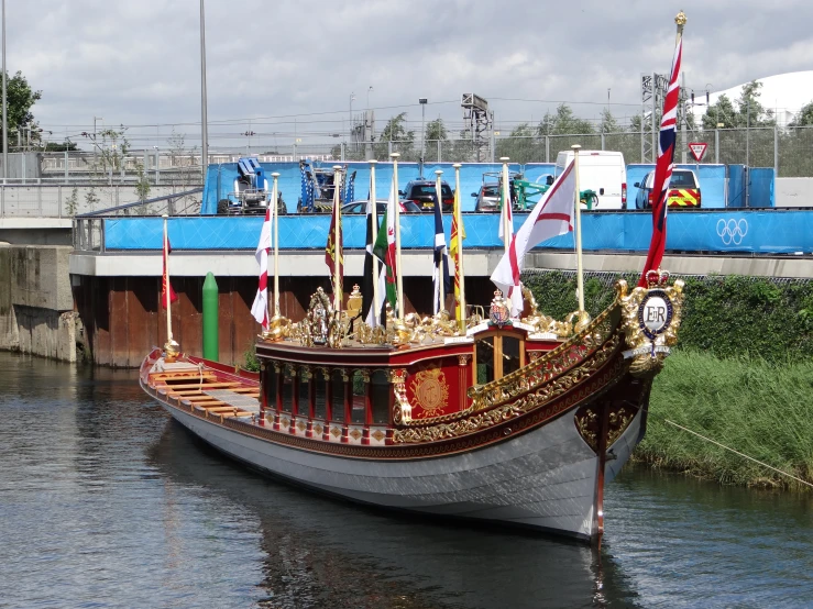 a boat on the water next to a bridge