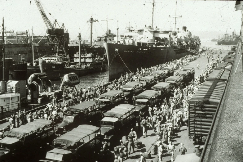 old black and white pograph of several large ships at dock