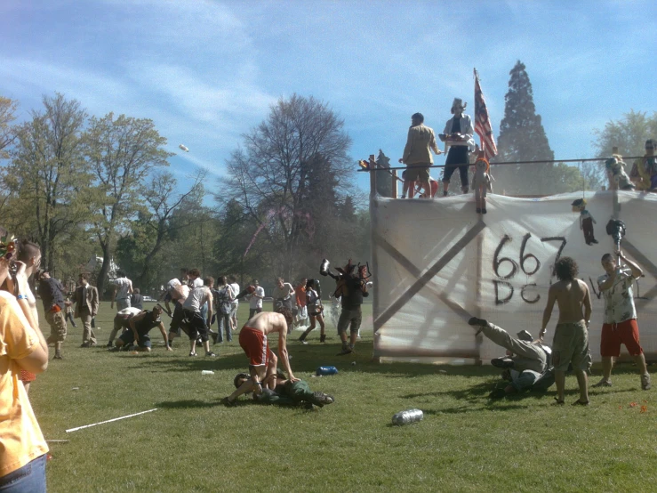 a group of people standing on a large banner at a game