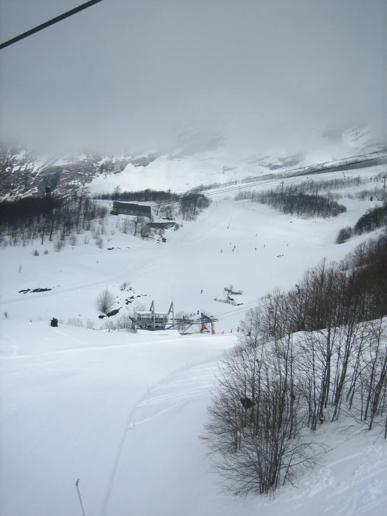 the snow covered terrain and a ski lift