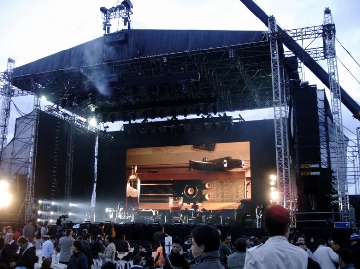 a concert scene with lots of people on stage