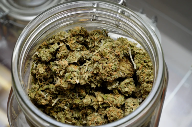 a glass jar filled with lots of weed