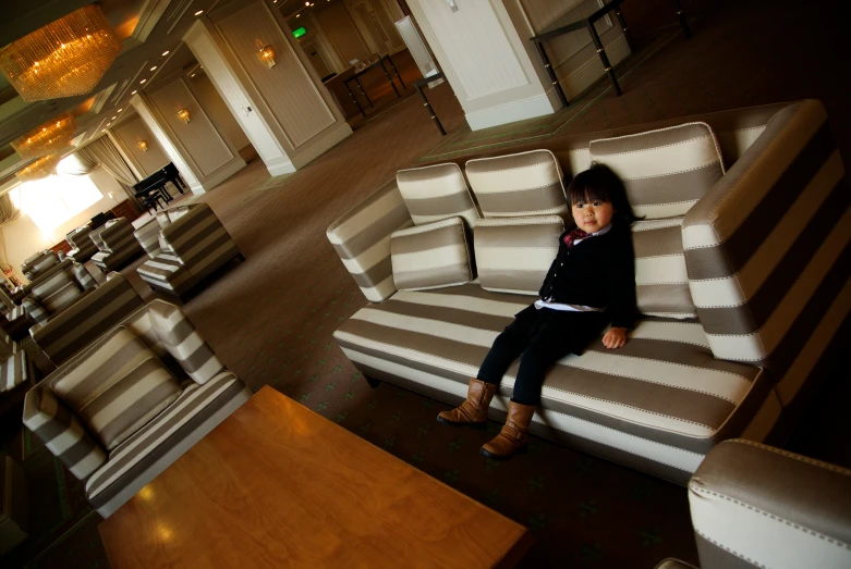 a little girl sitting on top of a chair