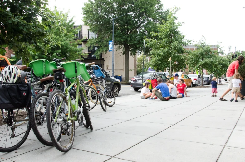 people sitting on the ground near some bikes