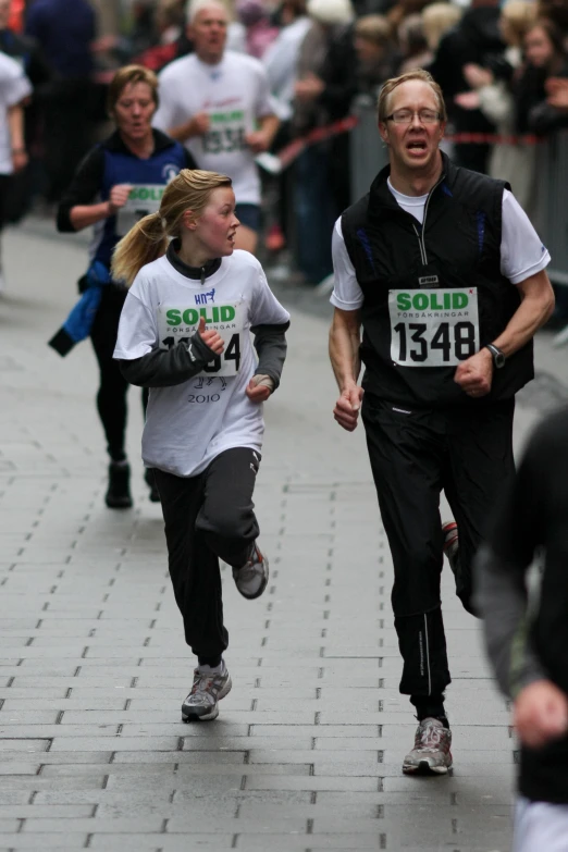 two people in running gear running down a street