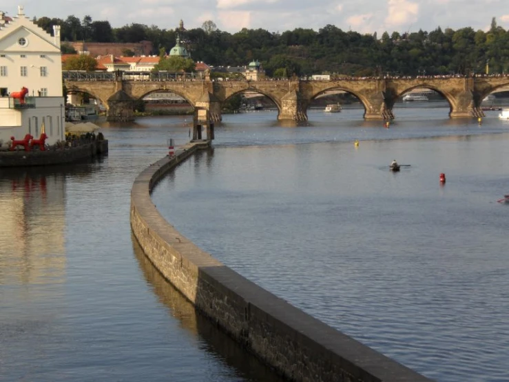 two people row on their small boats down a river