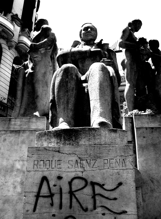 a group of statues sitting on top of cement