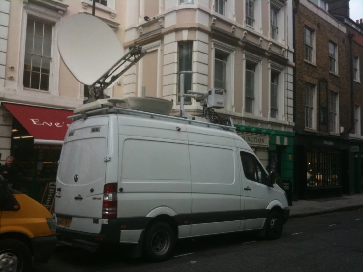 a van sits outside with its lights on