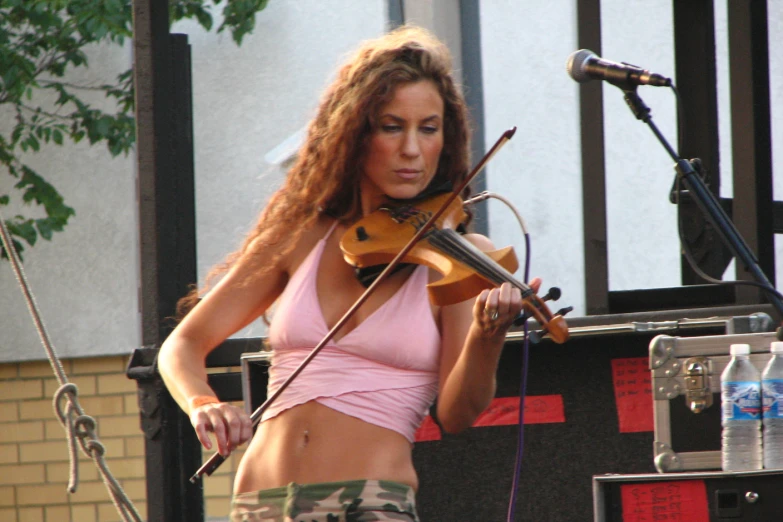 a woman wearing a  top holding a violin