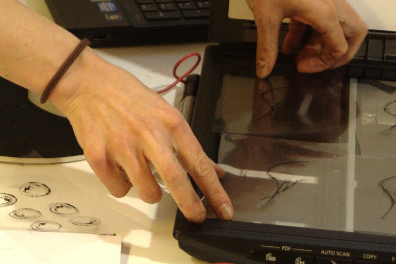 a person is touching the screen on their tablet