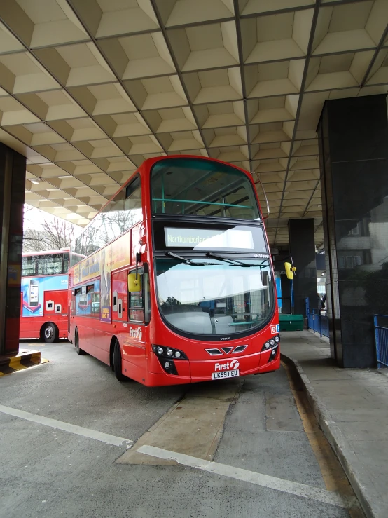 a double decked bus parked in a garage