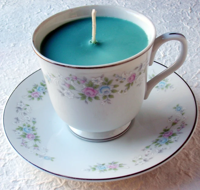 a tea cup with a candle in the middle