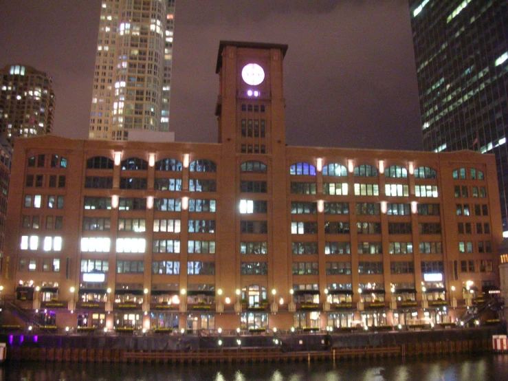 large building in front of city lights near a body of water