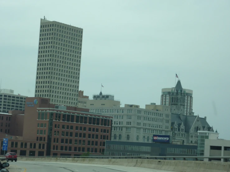 some buildings in the distance with cars driving by