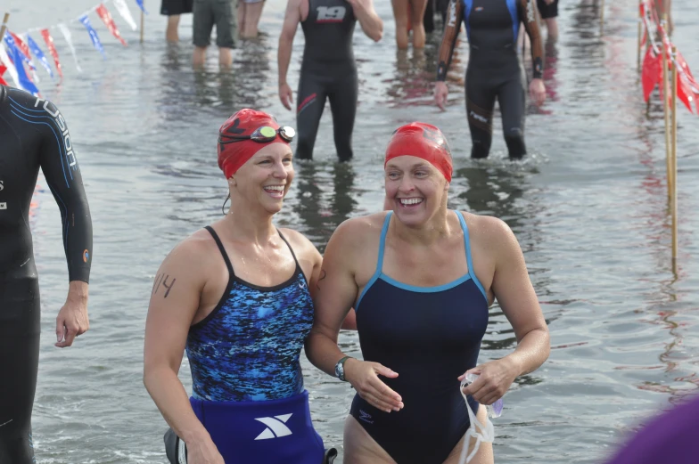 two women standing in the water at a competition