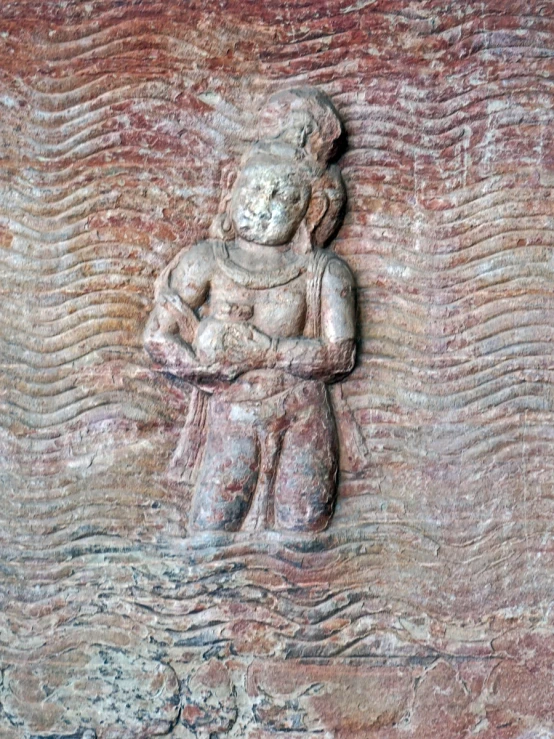 an ancient carving of the buddha god with waves