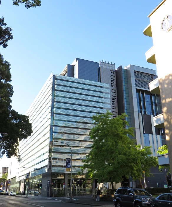 a tall building with many windows and trees