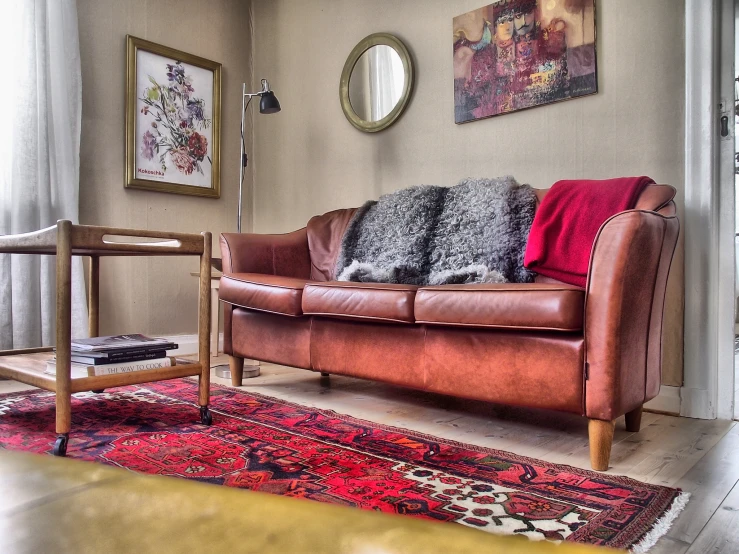 a living room with two leather sofas and a colorful rug