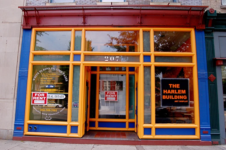 a shop front with advertising on it for an art exhibit