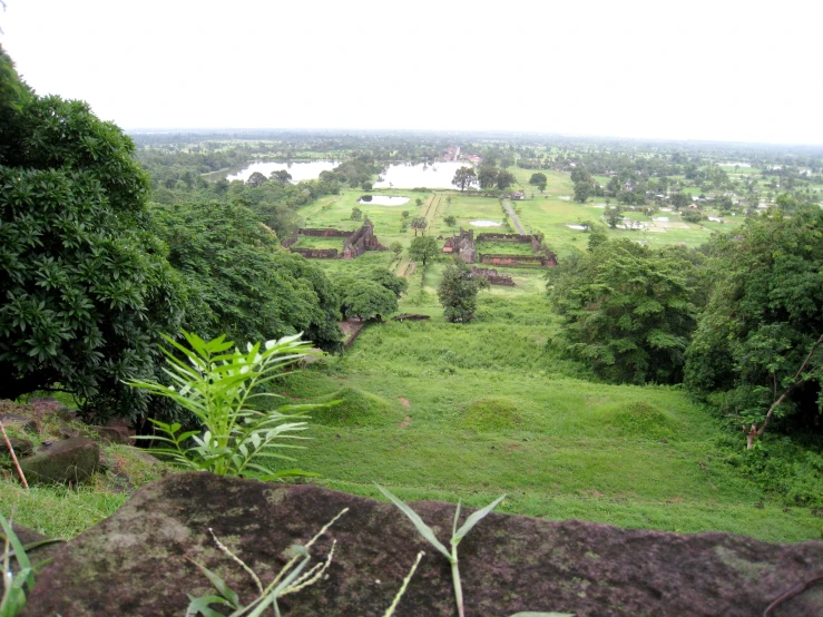 a hill top view of a lush green area