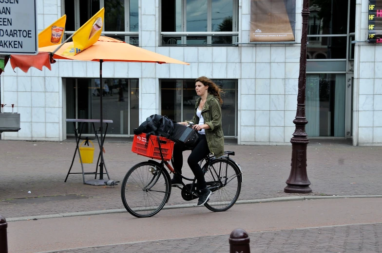 the woman is riding a bicycle with her luggage